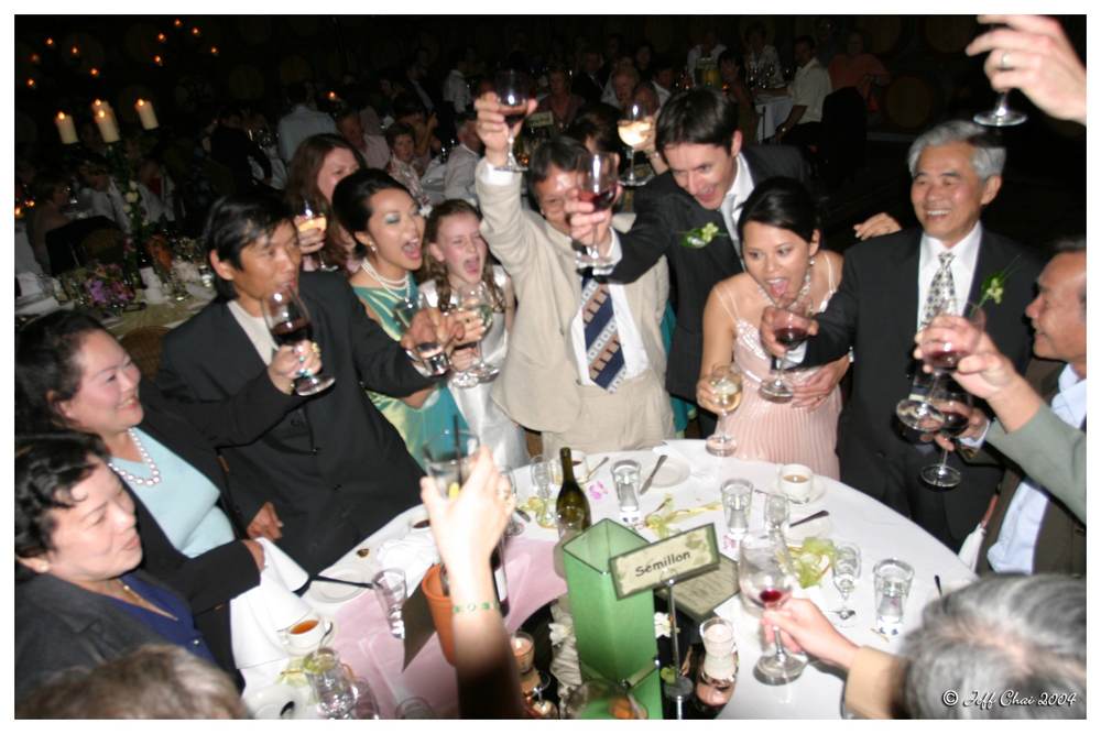 Guests raising glasses in a toast at a wedding celebration